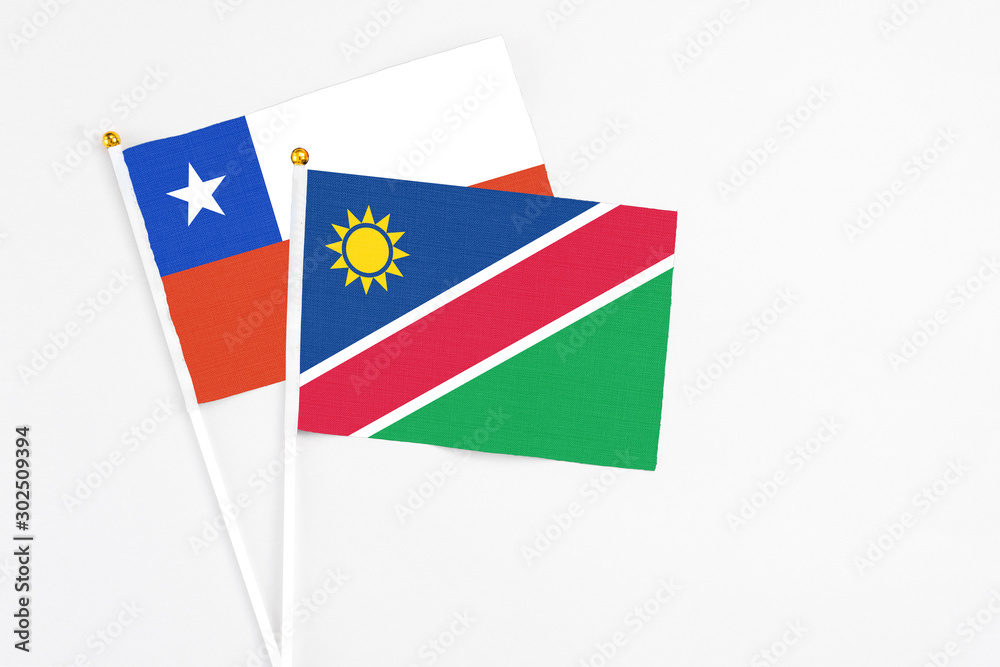 Namibia and Chile stick flags on white background. High quality fabric, miniature national flag. Peaceful global concept.White floor for copy space. Namibia and Chile stick flags on white background. High quality fabric, miniature national flag. Peaceful global concept.White floor for copy space.