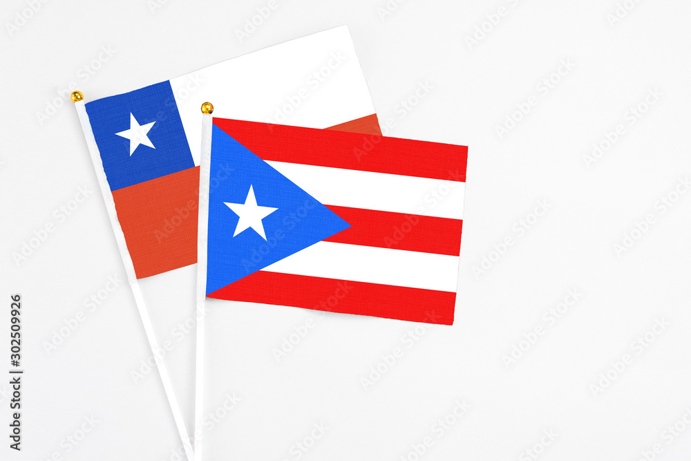 Puerto Rico and Chile stick flags on white background. High quality fabric, miniature national flag. Peaceful global concept.White floor for copy space. Puerto Rico and Chile stick flags on white background. High quality fabric, miniature national flag. Peaceful global concept.White floor for copy space.