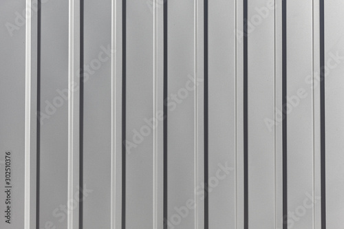 Corrugated metal texture of grey colour.