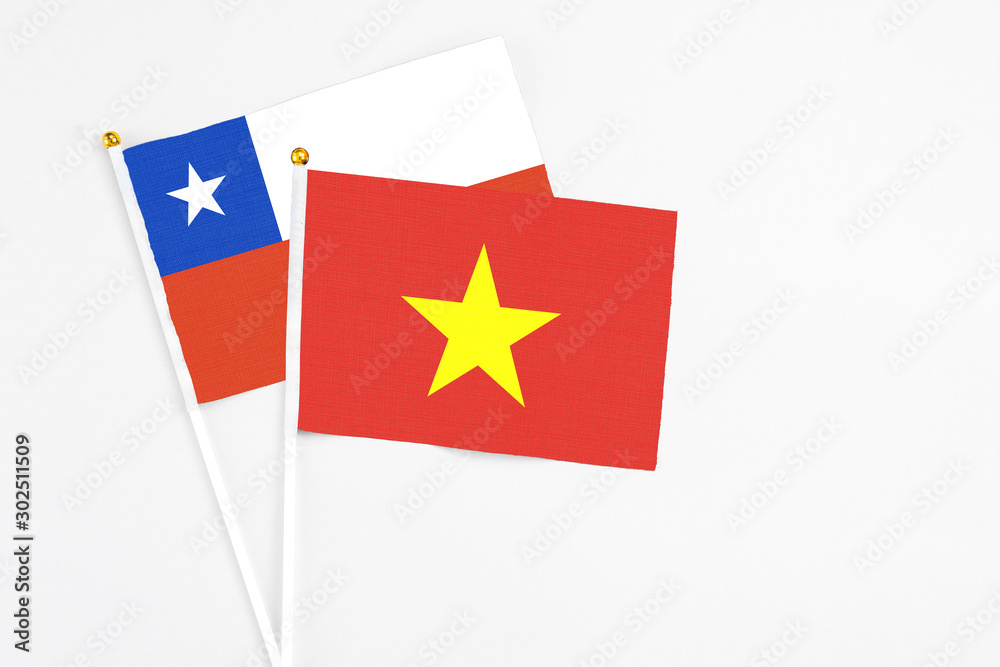 Vietnam and Chile stick flags on white background. High quality fabric, miniature national flag. Peaceful global concept.White floor for copy space. Vietnam and Chile stick flags on white background. High quality fabric, miniature national flag. Peaceful global concept.White floor for copy space.