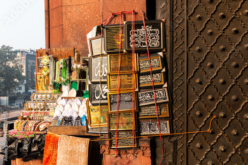 Quranic Verses printed frame decoration for sale at entrance gate to Jama Masjid, Mosque, Old Delhi, India photo