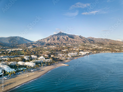 Beautiful aerial Panoramic View of Marbella, Nueva Andalucia and Puerto Banus area. Beautiful colours at sunset. La Concha mountain in background. 