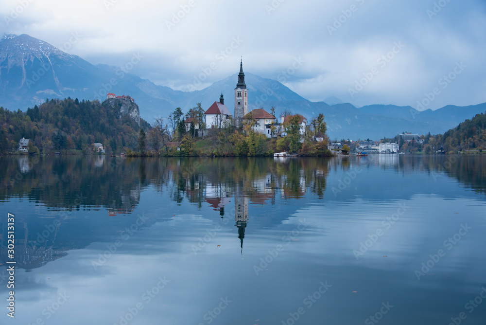 Calm view of Pilgrimage Church of the Assumption of Maria on lake Bled with beautiful clear reflection in the water Calm view of Pilgrimage Church of the Assumption of Maria on lake Bled with beautiful clear reflection in the water