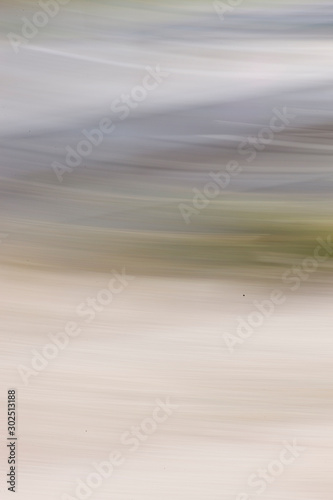 Motion blurred foliage and forest. Natural abstract background with blurry forest photographed with moving camera