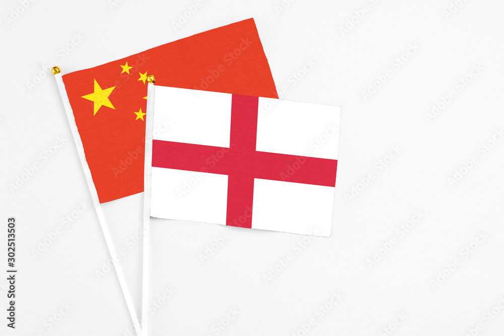 England and China stick flags on white background. High quality fabric, miniature national flag. Peaceful global concept.White floor for copy space.