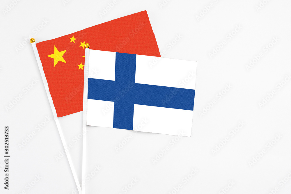 Finland and China stick flags on white background. High quality fabric, miniature national flag. Peaceful global concept.White floor for copy space.