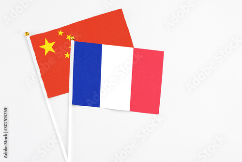 Free Download France and China stick flags on white background. High quality fabric, miniature national flag. Peaceful global concept.White floor for copy space. - GFXLoad
