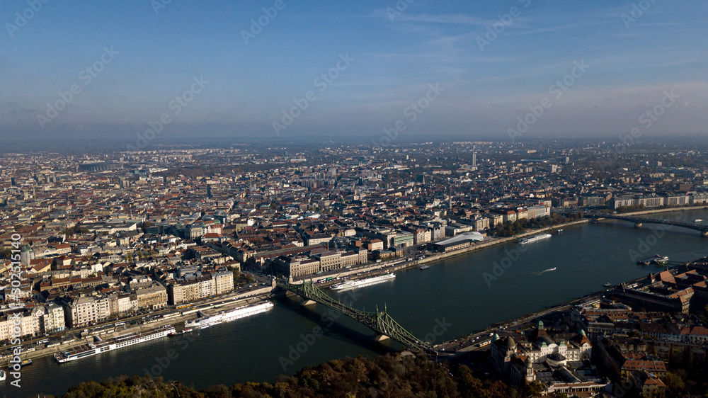 Fototapeta premium View of Budapest and the capital of Hungary from a height shooting on a drone. The main attractions in the city panorama, bridges, the old city, the palace, parliament. Top view.