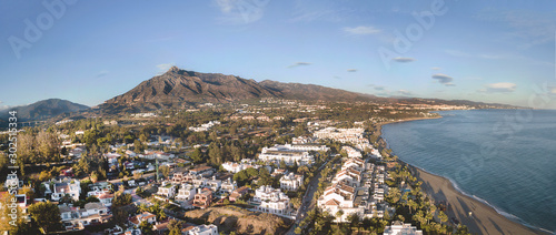 Beautiful aerial Panoramic View of Marbella, Nueva Andalucia and Puerto Banus area. Beautiful colours at sunset. La Concha mountain in background.  photo