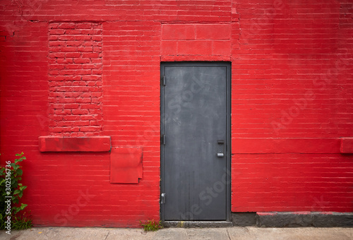 Steel door in an old red brick wall