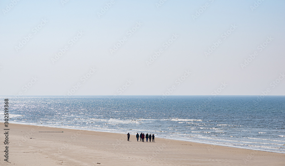 Beach of Baltic sea with people walking