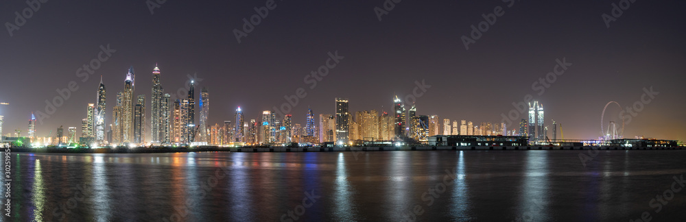 Dubai skyline panorama at night showing beautiful JBR seafront skyscrapers 
