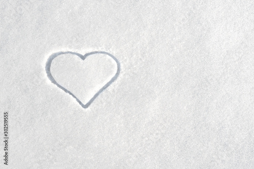 Symbol of heart on white snow background. Symbol of love on white background. Love concept. Copy space. Symbol of the strongest feeling of love.