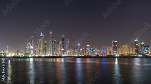 JBR skyline at night full of colorful lights reflections on the water