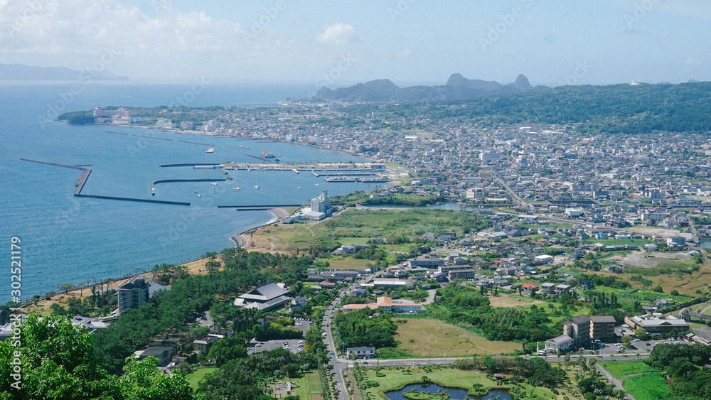 Aerial view of the countryside city with a sea view and fishing ports mixing highway roads in Japan. Ibusuki, Kumamoto, Japan