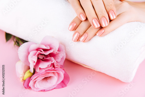 Beautiful Woman Hands . Spa and Manicure concept. Female hands with pink manicure. Soft skin skincare concept. Beauty nails. Over beige background