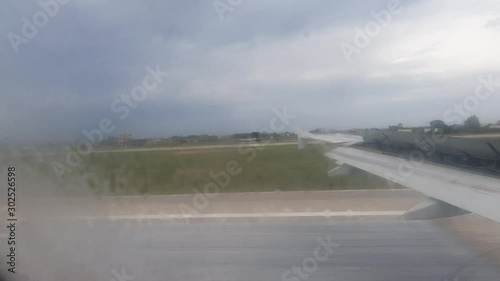 Airplane Landing from the Passenger View. Flying over the Sea and Landing on the Airport photo