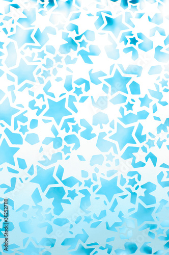 Festive full frame background of textured outlines of wintry blue and white star shapes