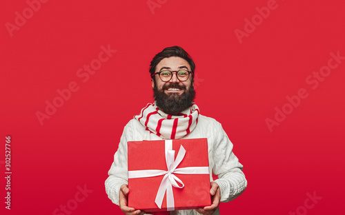 Delighted guy carrying Christmas gift © kegfire