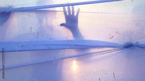 Moving figures of young man and woman behind a white fabric. Concept of barriers, borders, prohibition, obstacles, unfreedom.