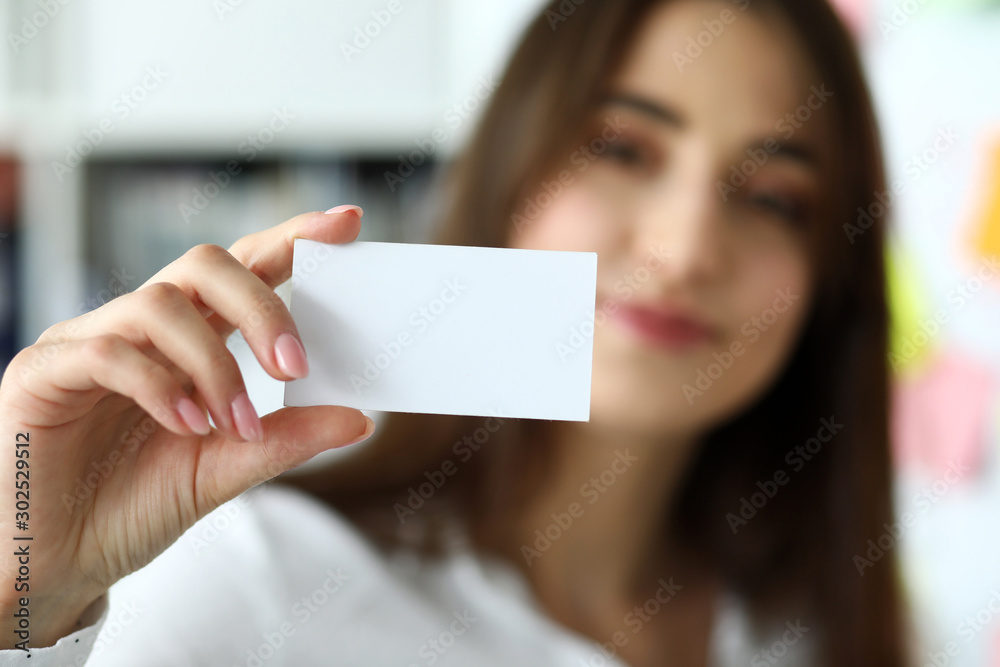 Female arm in suit give blank calling card to visitor Female arm in suit give blank calling card to visitor