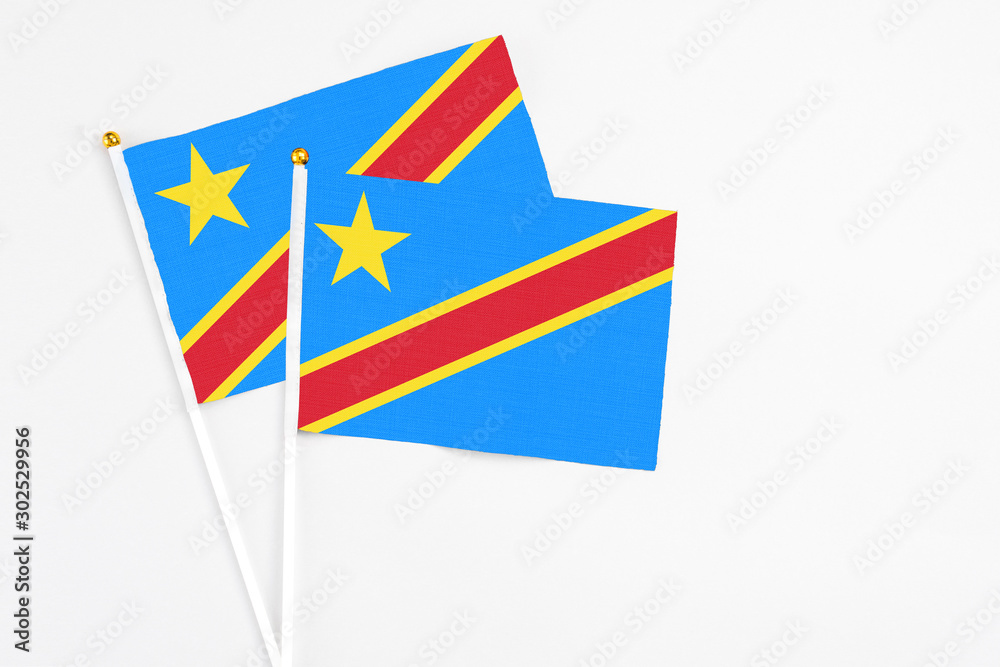 Congo and Congo stick flags on white background. High quality fabric, miniature national flag. Peaceful global concept.White floor for copy space.