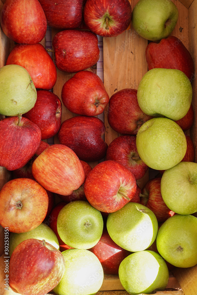 red and green apples in a wooden crate red and green apples in a wooden crate