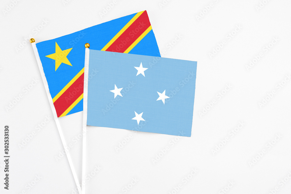 Micronesia and Congo stick flags on white background. High quality fabric, miniature national flag. Peaceful global concept.White floor for copy space. Micronesia and Congo stick flags on white background. High quality fabric, miniature national flag. Peaceful global concept.White floor for copy space.