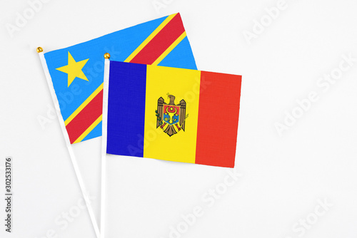 Moldova and Congo stick flags on white background. High quality fabric, miniature national flag. Peaceful global concept.White floor for copy space.