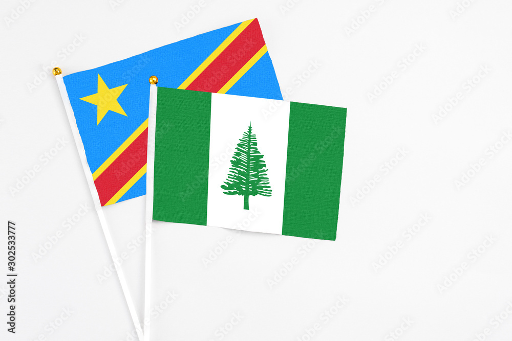 Norfolk Island and Congo stick flags on white background. High quality fabric, miniature national flag. Peaceful global concept.White floor for copy space. Norfolk Island and Congo stick flags on white background. High quality fabric, miniature national flag. Peaceful global concept.White floor for copy space.