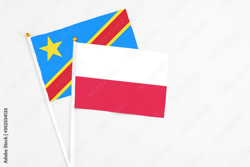 Poland and Congo stick flags on white background. High quality fabric, miniature national flag. Peaceful global concept.White floor for copy space.