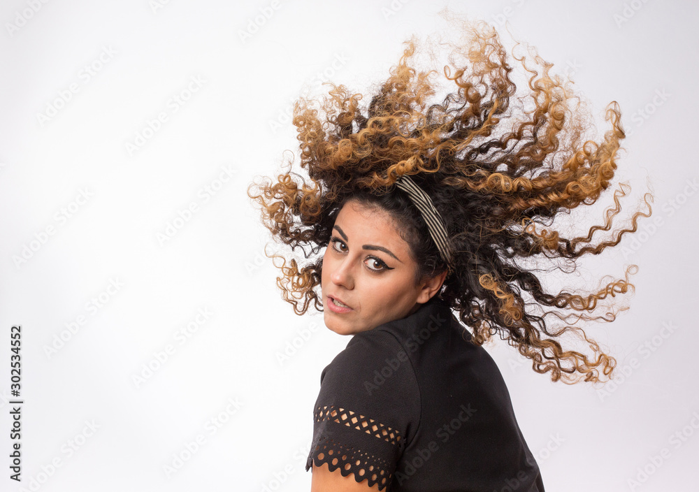 Fototapeta premium Woman moving curly hair