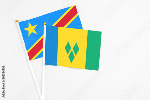 Saint Vincent And The Grenadines and Congo stick flags on white background. High quality fabric, miniature national flag. Peaceful global concept.White floor for copy space.