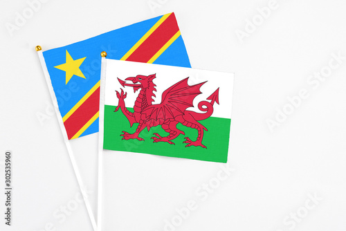 Wales and Congo stick flags on white background. High quality fabric  miniature national flag. Peaceful global concept.White floor for copy space.