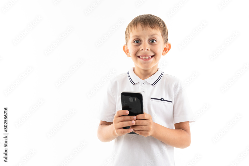 Portrait of happy caucasian boy chatting with his friends or playing phone games, wins and smiles Portrait of happy caucasian boy chatting with his friends or playing phone games, wins and smiles