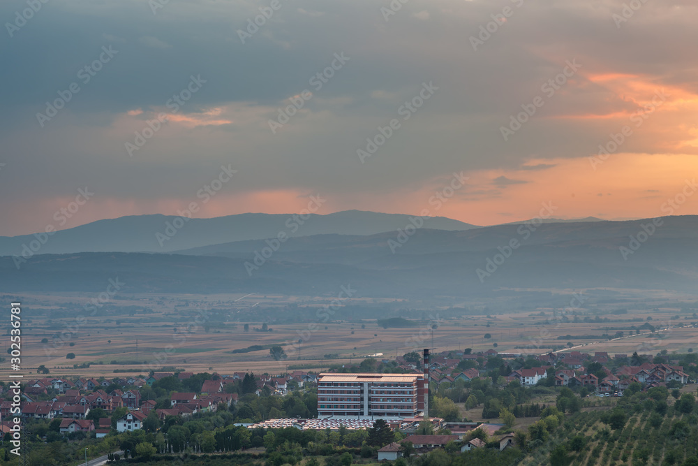 Hospital in Pirot, Serbia, viewed from above, with it's roof reflecting the golden light of a setting sun