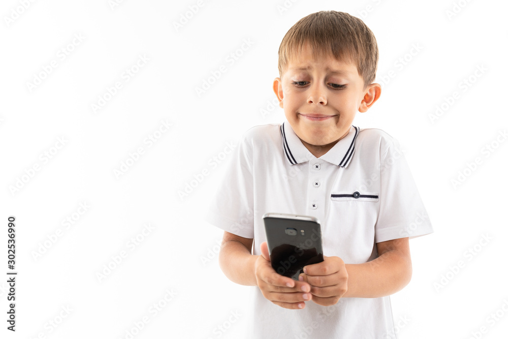 Portrait of happy caucasian boy chatting with his friends or playing phone games and sad Portrait of happy caucasian boy chatting with his friends or playing phone games and sad