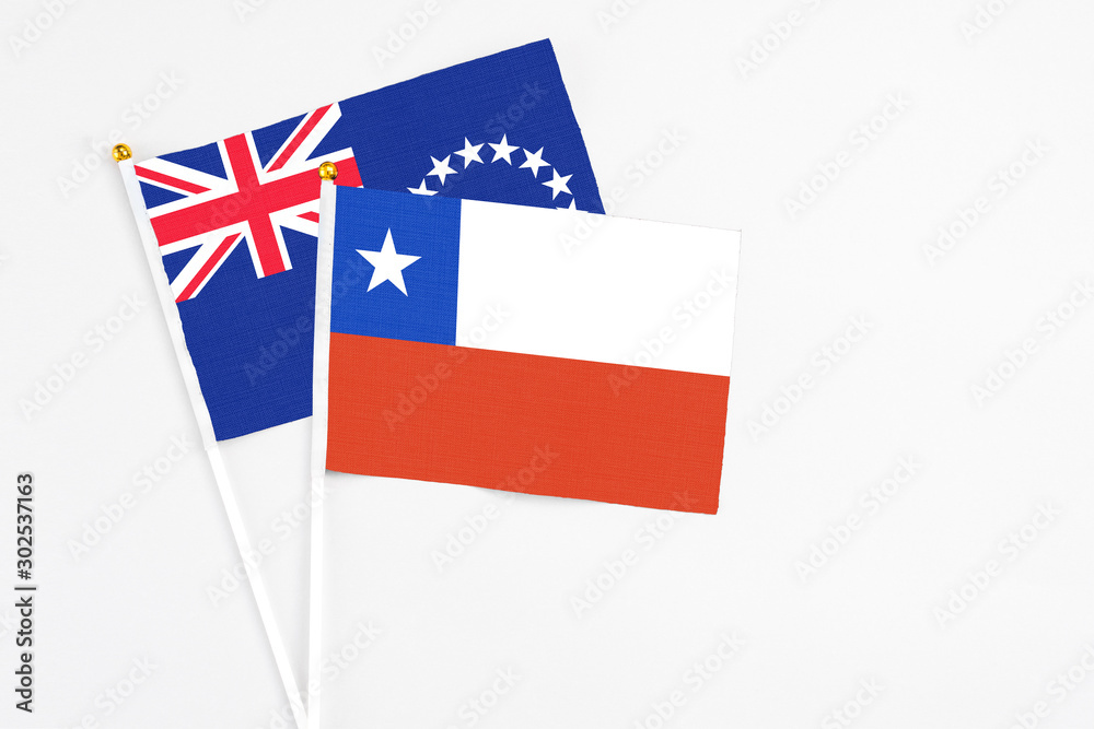 Chile and Cook Islands stick flags on white background. High quality fabric, miniature national flag. Peaceful global concept.White floor for copy space.