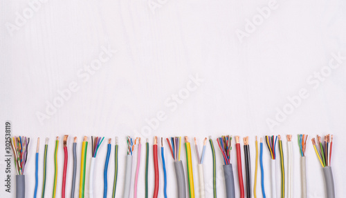 Electric wires on white background, top view with copy space