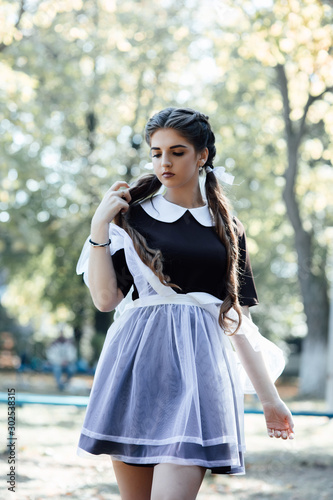 Diligent schoolgirl. School education concept. Knowledge day. Girl with braids ready for school. School fashion concept. Girl wear school uniformt outdoor. Beautiful girl long tied hair in ponytails.