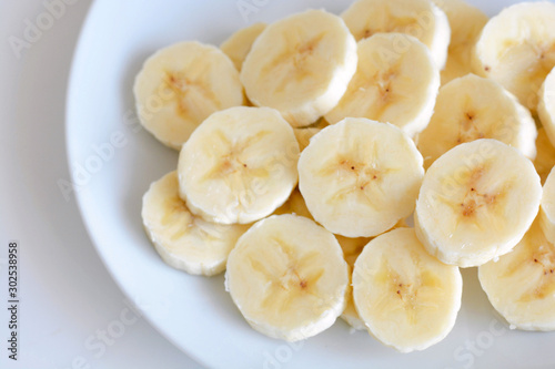 Banana slices on a white plate.