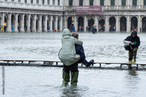 VENICE, ITALY - November 12, 2019: St. Marks Square (Piazza San Marco) during flood (acqua alta) in Venice, Italy. Venice high water.
