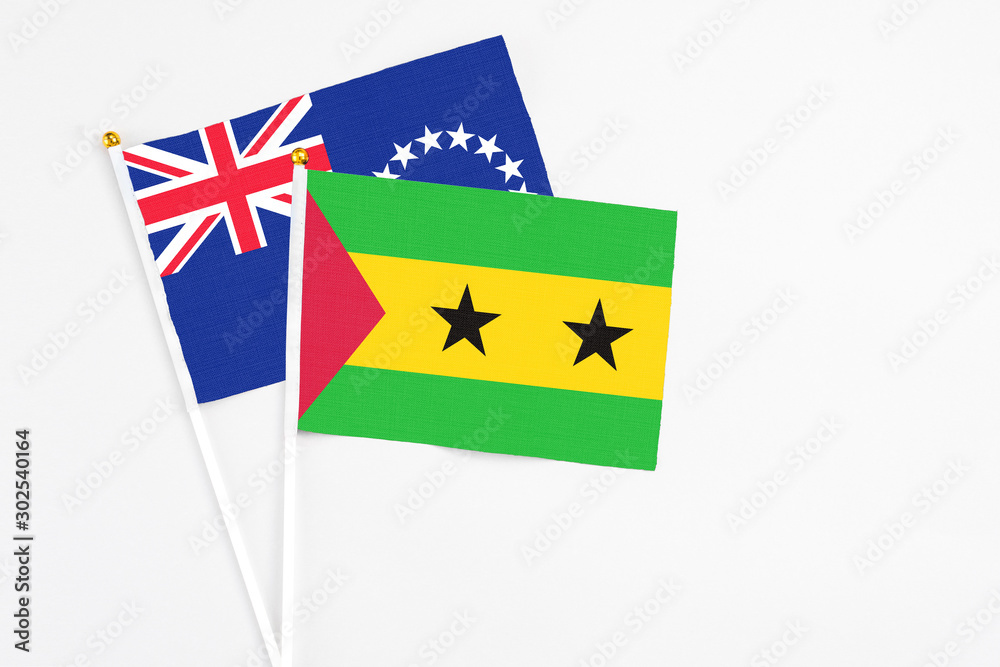 Sao Tome And Principe and Cook Islands stick flags on white background. High quality fabric, miniature national flag. Peaceful global concept.White floor for copy space. Sao Tome And Principe and Cook Islands stick flags on white background. High quality fabric, miniature national flag. Peaceful global concept.White floor for copy space.