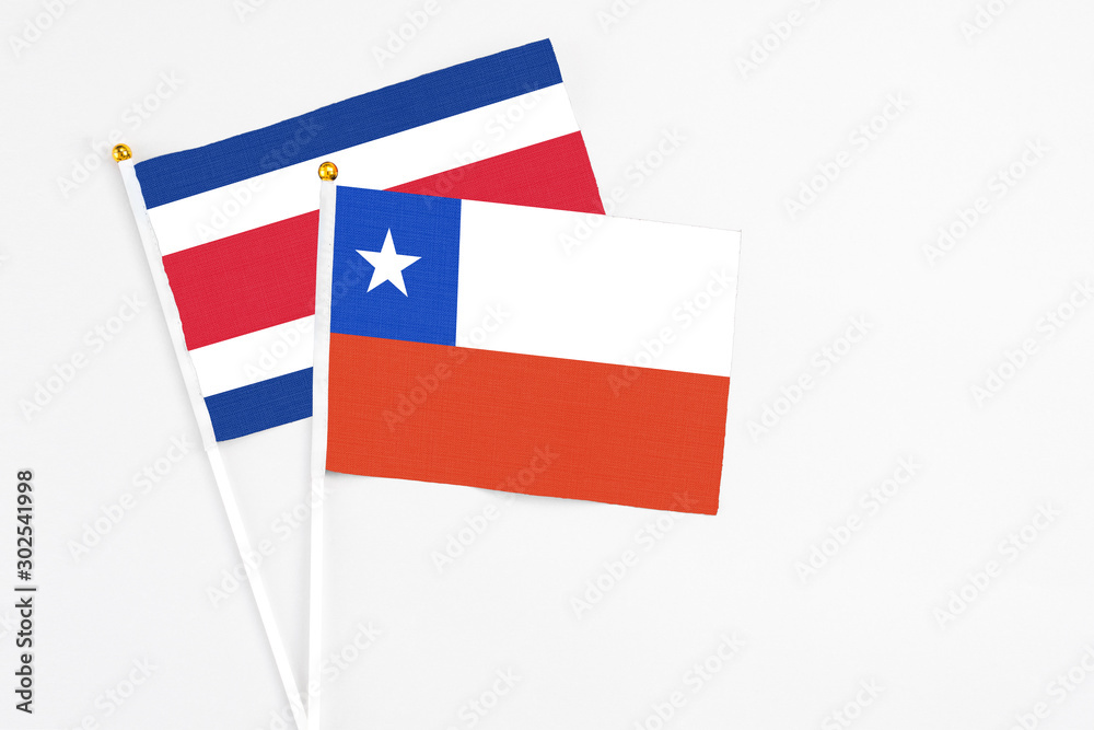 Chile and Costa Rica stick flags on white background. High quality fabric, miniature national flag. Peaceful global concept.White floor for copy space. Chile and Costa Rica stick flags on white background. High quality fabric, miniature national flag. Peaceful global concept.White floor for copy space.