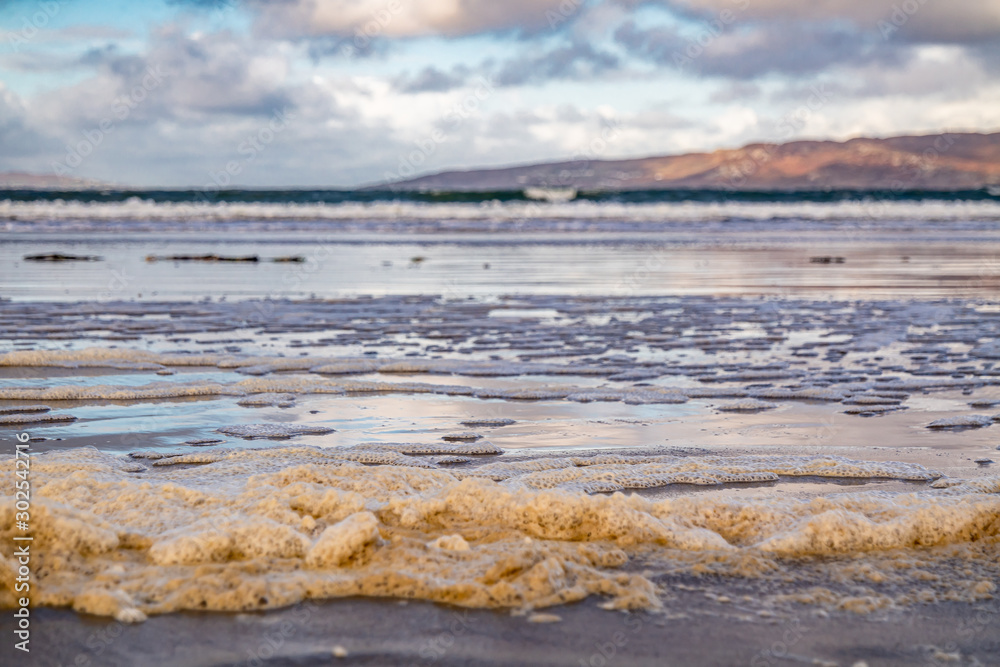 Sea foam on the beach on beach in County Doneal - Ireland