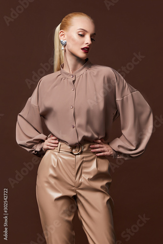 Sexy beautiful business woman lady boss CEO manager makeup long curly hair blond wear clothes office dress code suit jacket pants uniform work or date catalog accessory jewelry elegant style.
