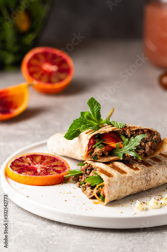 Tortilla wraps sandwiches with fresh vegetables, minced meat and