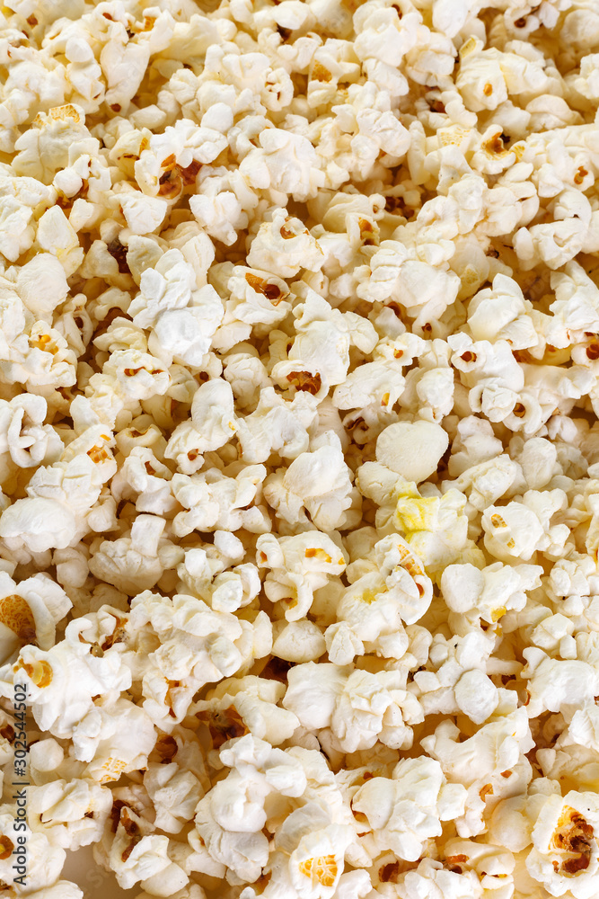Heap of delicious popcorn, isolated on white background . Scattered popcorn texture background. Top view.
