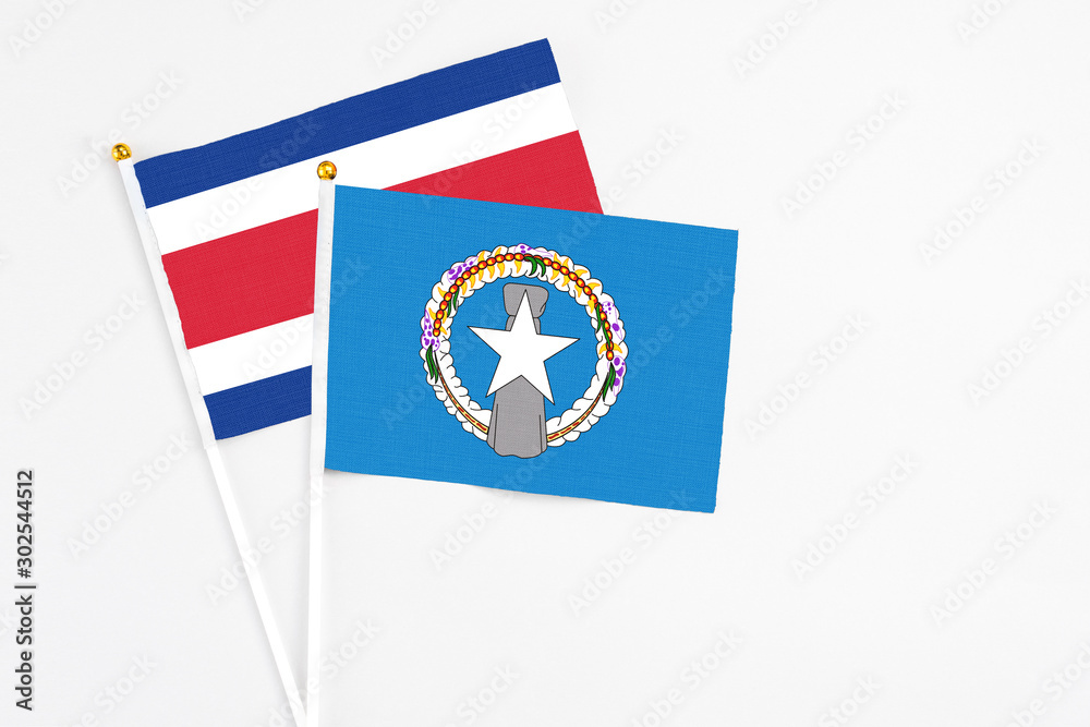 Northern Mariana Islands and Costa Rica stick flags on white background. High quality fabric, miniature national flag. Peaceful global concept.White floor for copy space. Northern Mariana Islands and Costa Rica stick flags on white background. High quality fabric, miniature national flag. Peaceful global concept.White floor for copy space.