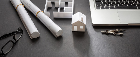 Construction concept. Residential building drawings and house model,